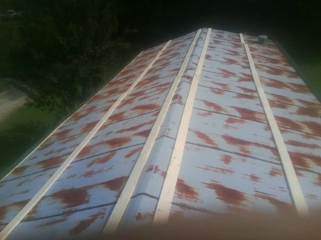 Rusted metal roof panels with new wood purlins before replacement — Storm Damage Roof Repair in Ramer by Roofing Brothers